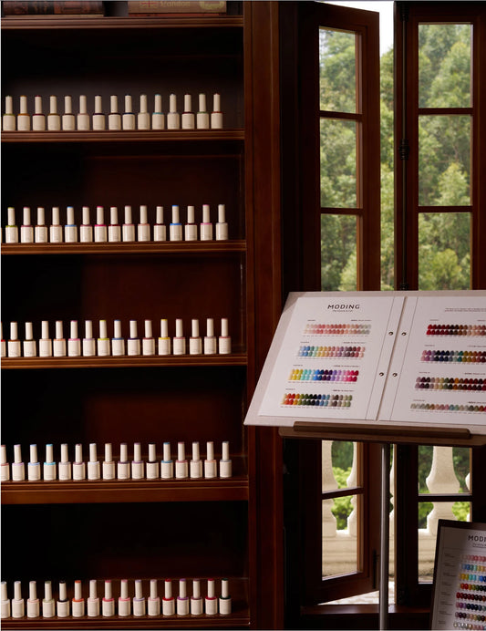 Moding Ebony & Cat color gel collection displayed in a wood cabinet