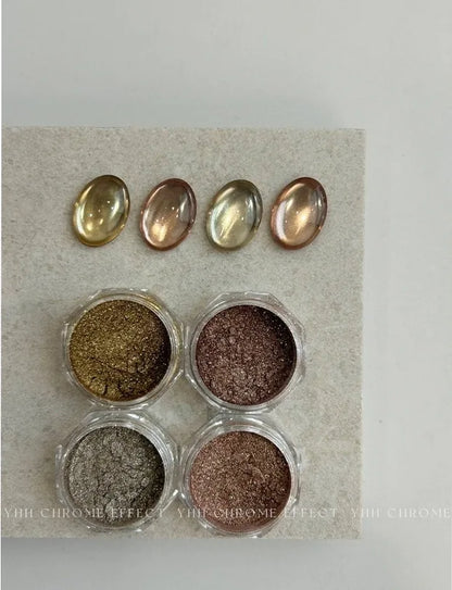 Open jars of earth-tone metallic chrome powder