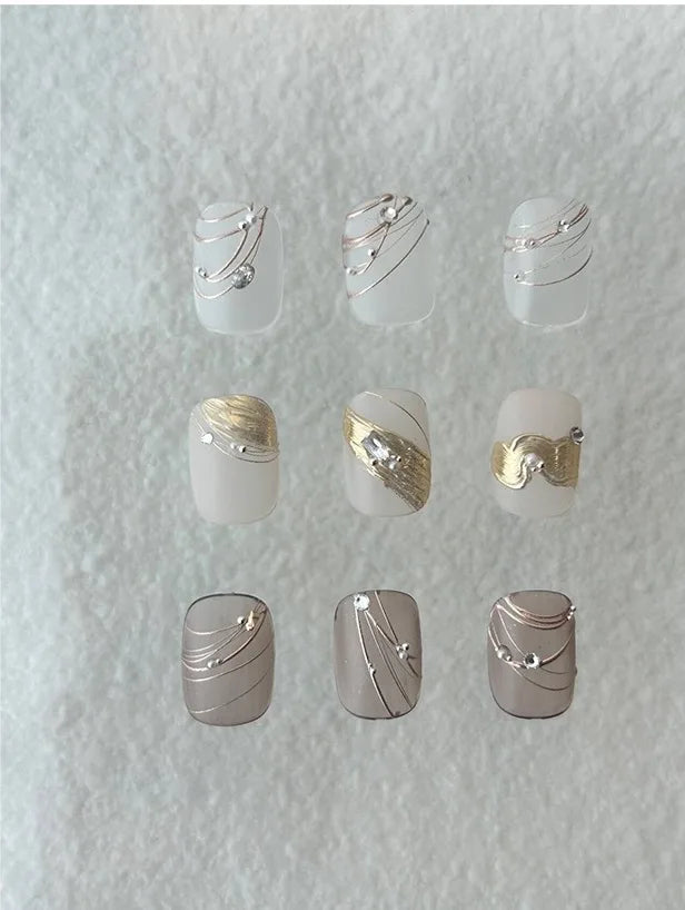 Nail art with metallic chrome lines and 3D details