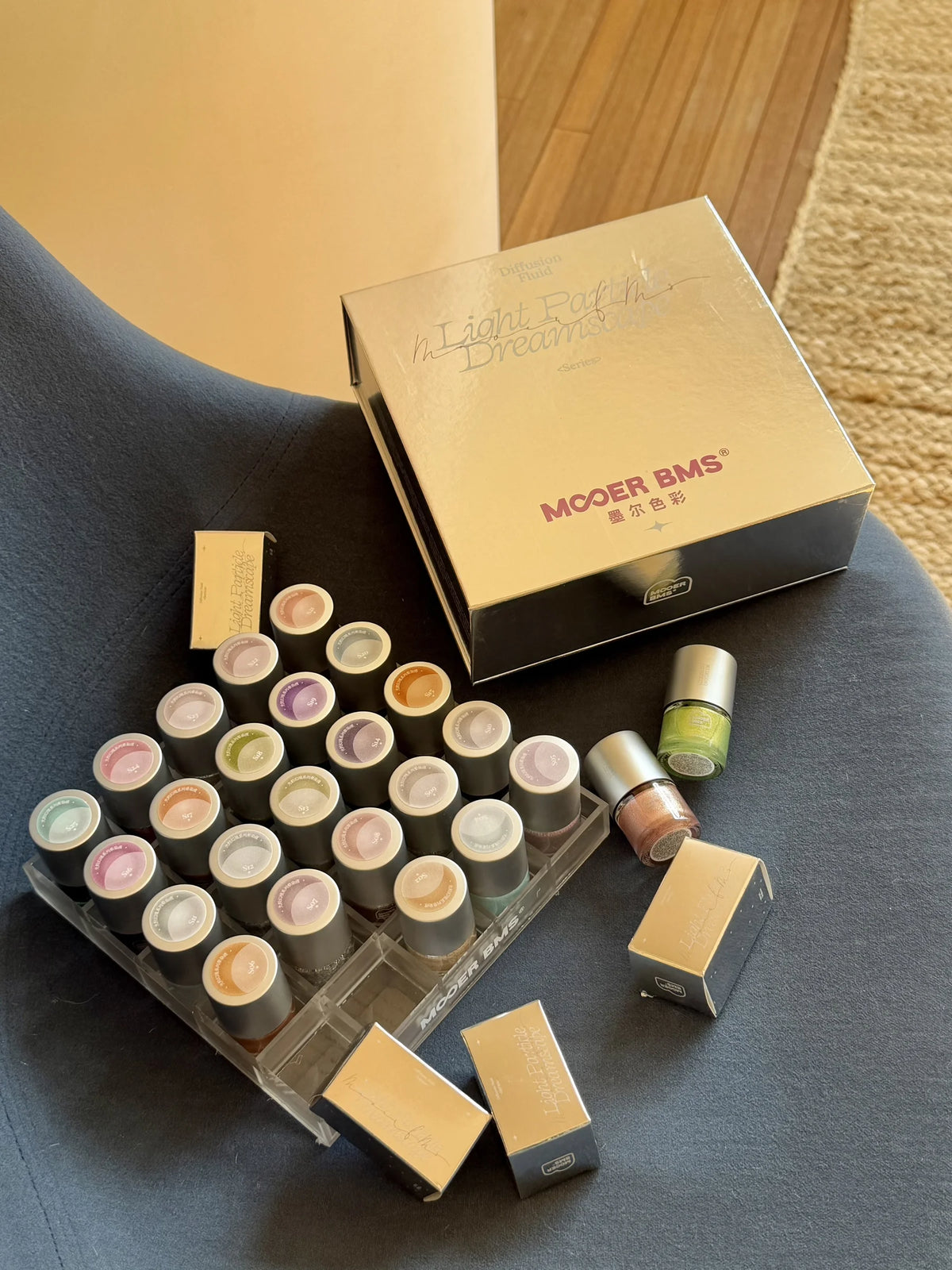 Holding the 25-bottle organizer next to the swatch stand
