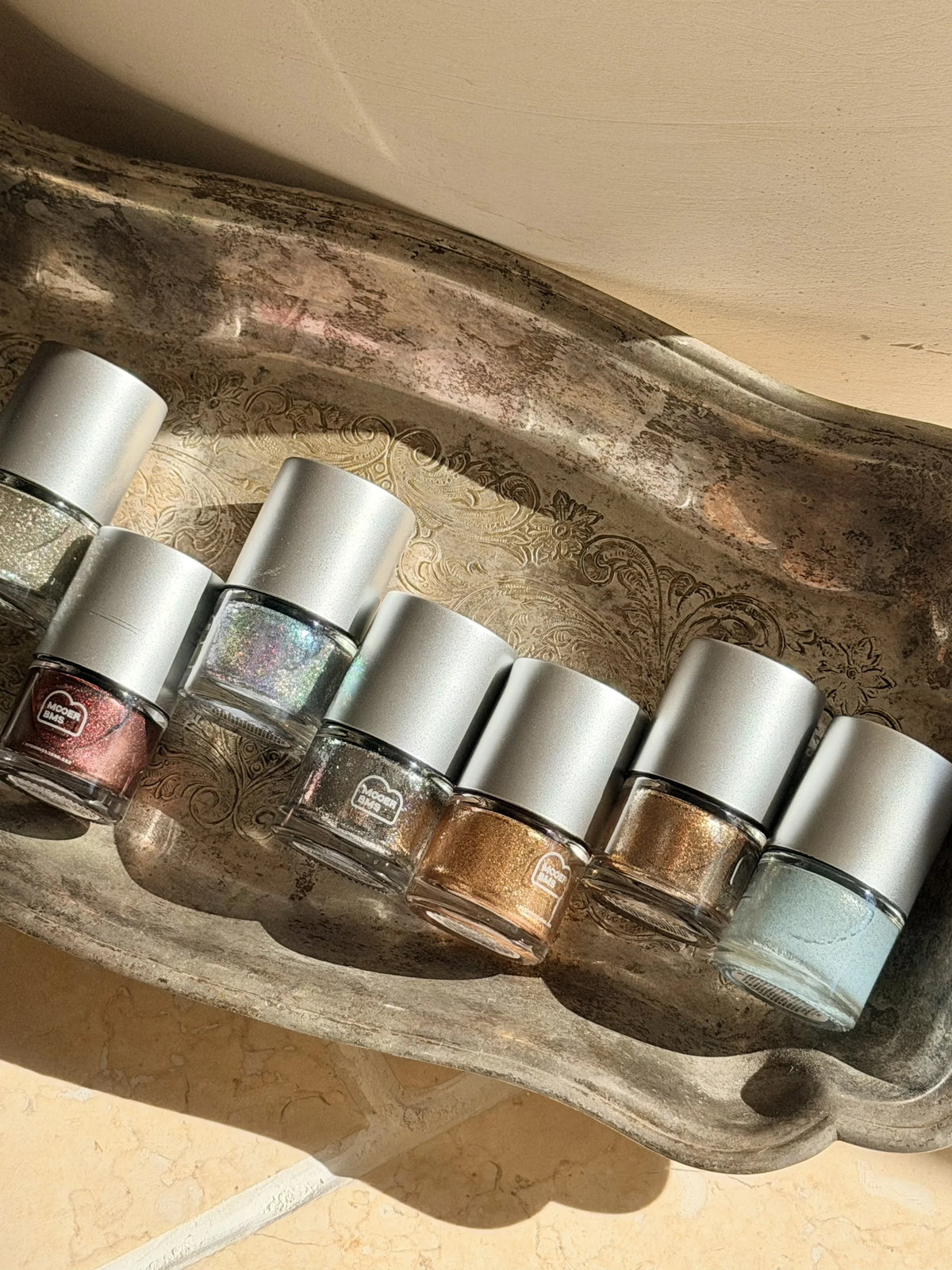 Bottles and color card beside the silver gift box