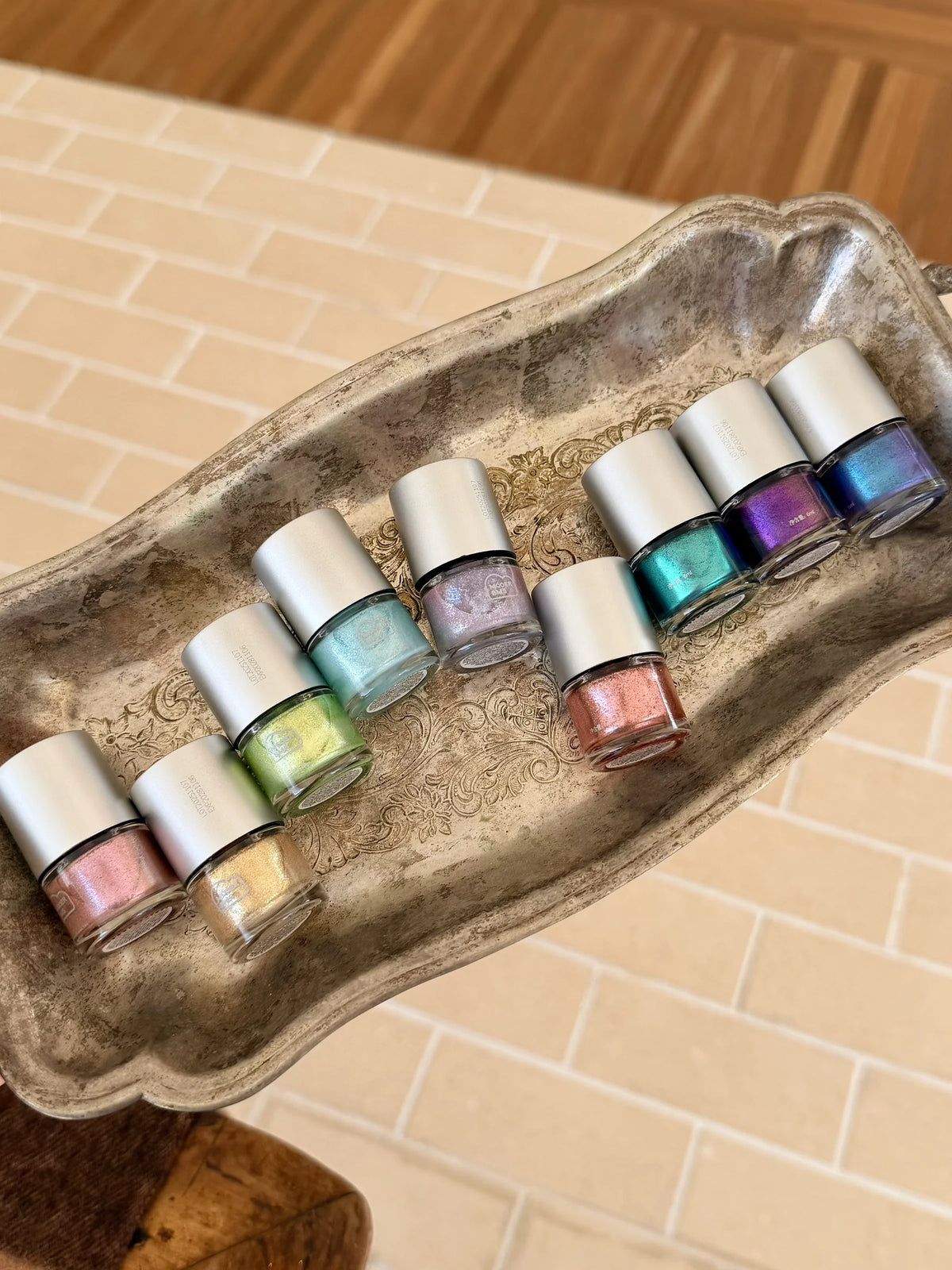 Glitter blooming ink bottles on a vintage silver tray