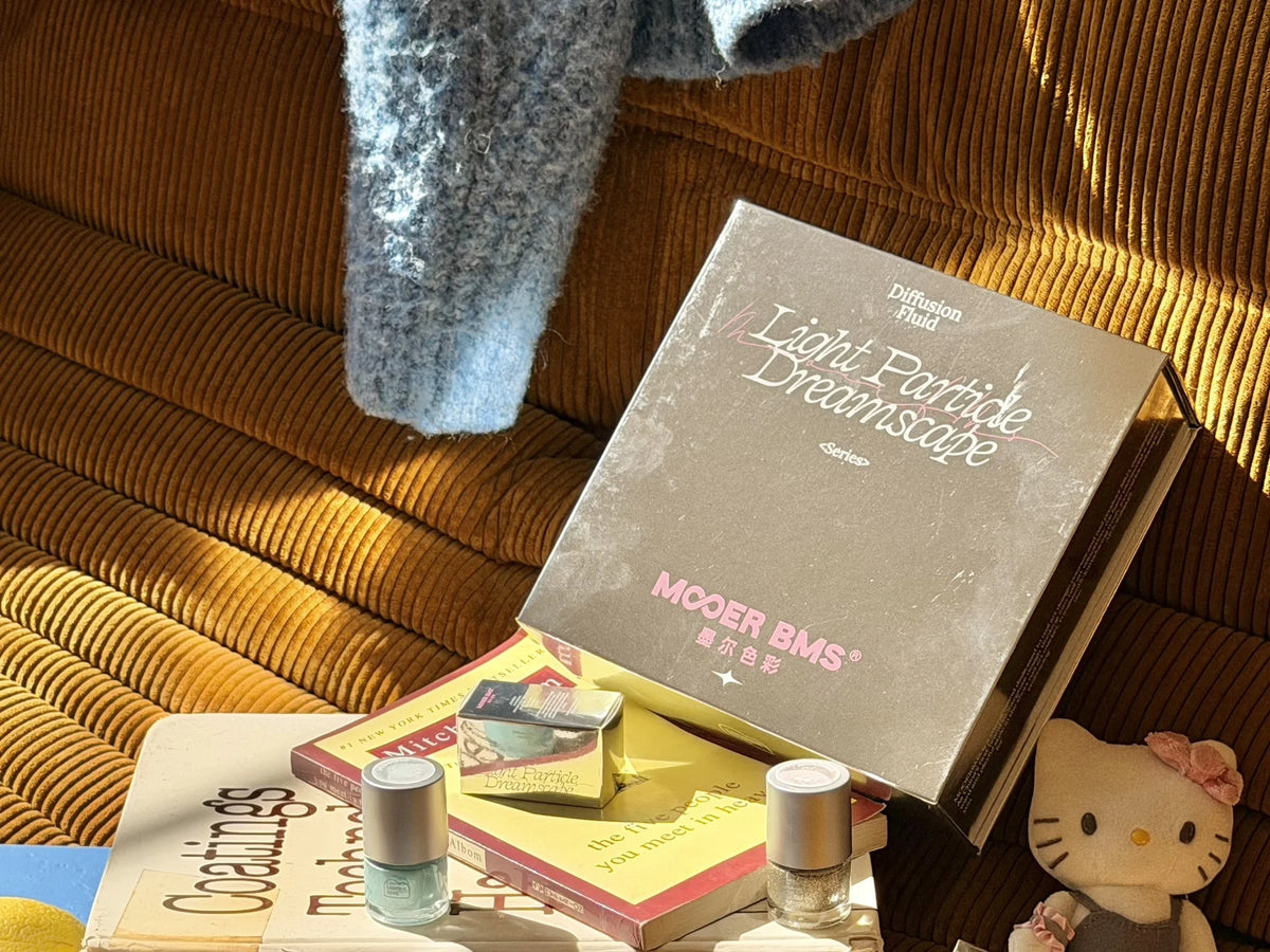 Light Particle Dreamscape box with bottles on a corduroy sofa