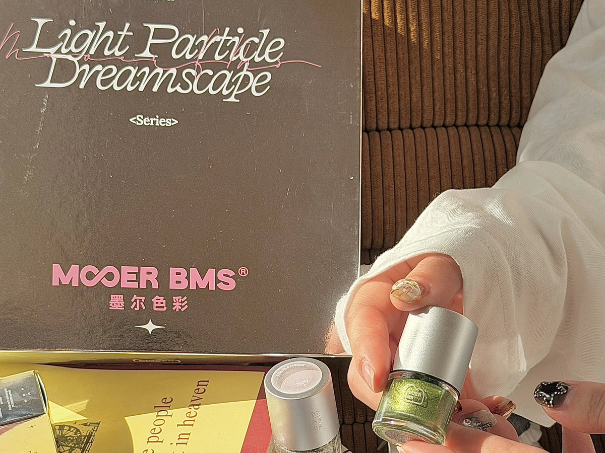 Holding a green glitter blooming ink in front of the series box