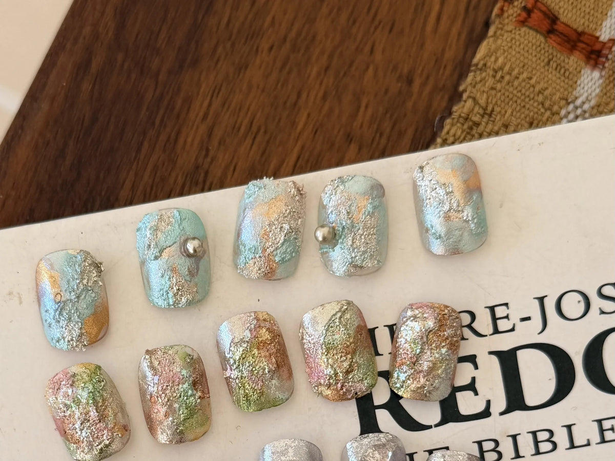 Nail tips with textured glitter bloom designs