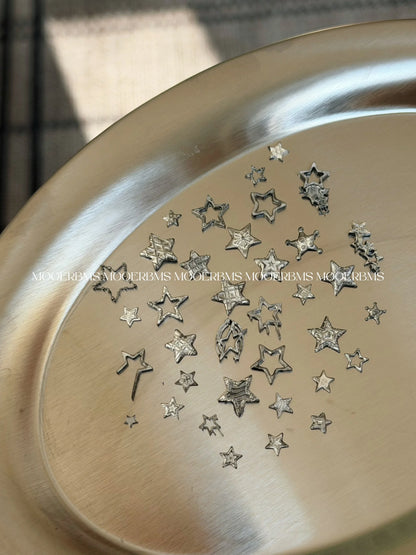 Silver chrome star charms from the Star Family mold on a metal tray