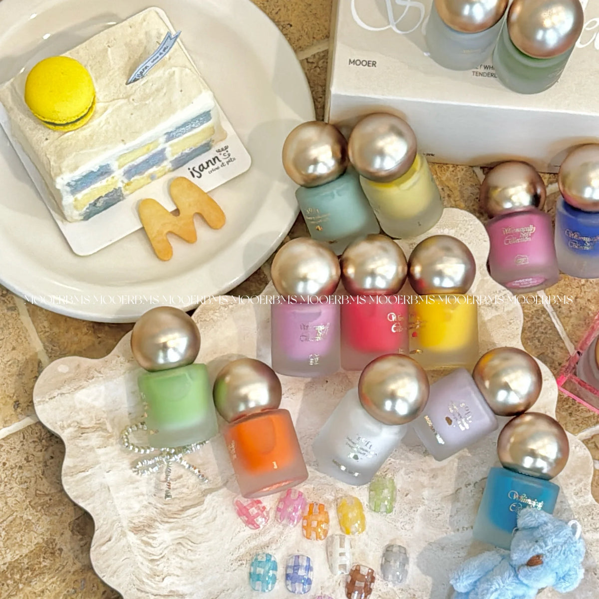 Whimsically Soft bottles with gold ball caps on a dessert table