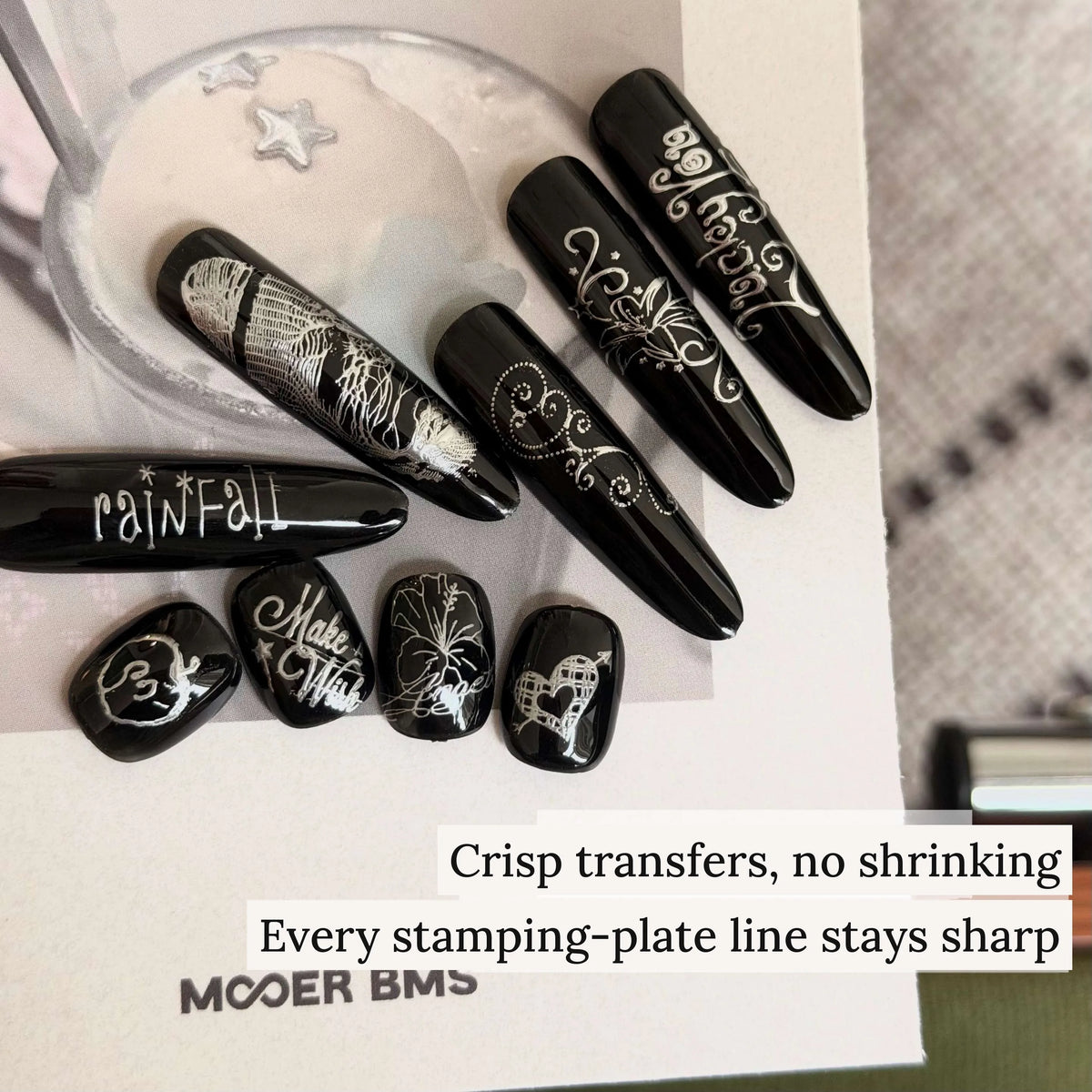 Crisp stamping-plate transfers in mirror silver on black nails