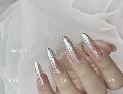 Silver Silk silk chrome powder worn on long almond nails over a sheer neutral base