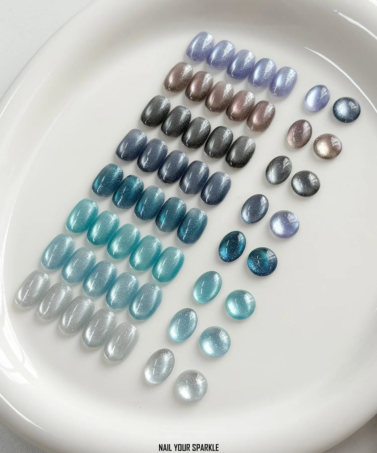 All eight Denim Cat Eye shades swatched on a white plate