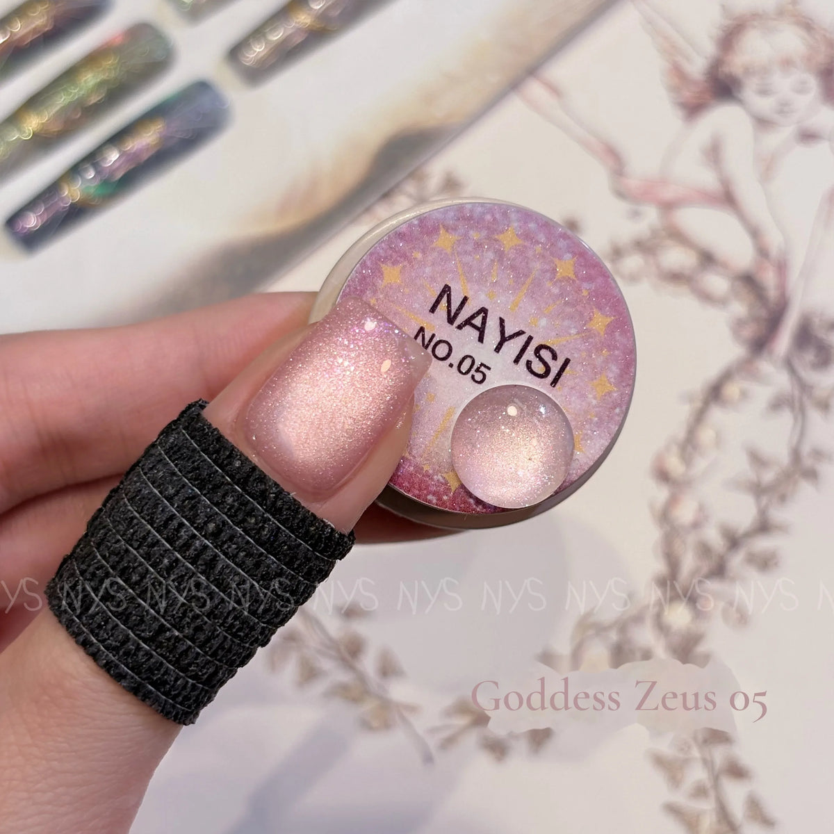 Goddess Zeus 05, pink champagne cat eye, on a nail beside its jar