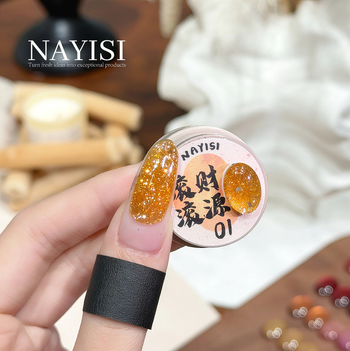 Riches and Treasures 3.0 01, golden amber glitter, on a nail beside its jar