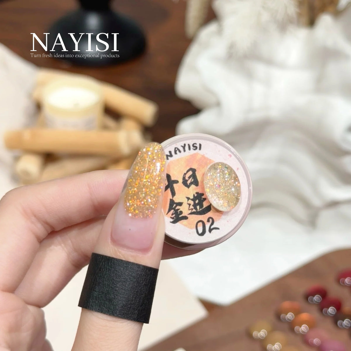 Riches and Treasures 3.0 02, champagne gold glitter, on a nail beside its jar