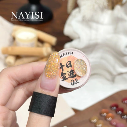 Riches and Treasures 3.0 02, champagne gold glitter, on a nail beside its jar