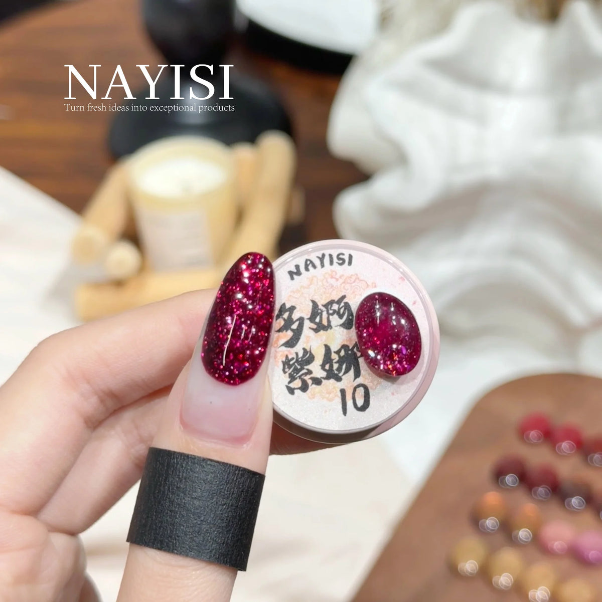 Riches and Treasures 3.0 10, deep berry glitter, on a nail beside its jar