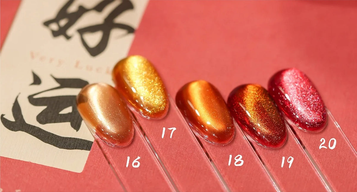 Cat eye shades 16-20 on nail tips: peach, gold, tangerine, red-orange and strawberry red