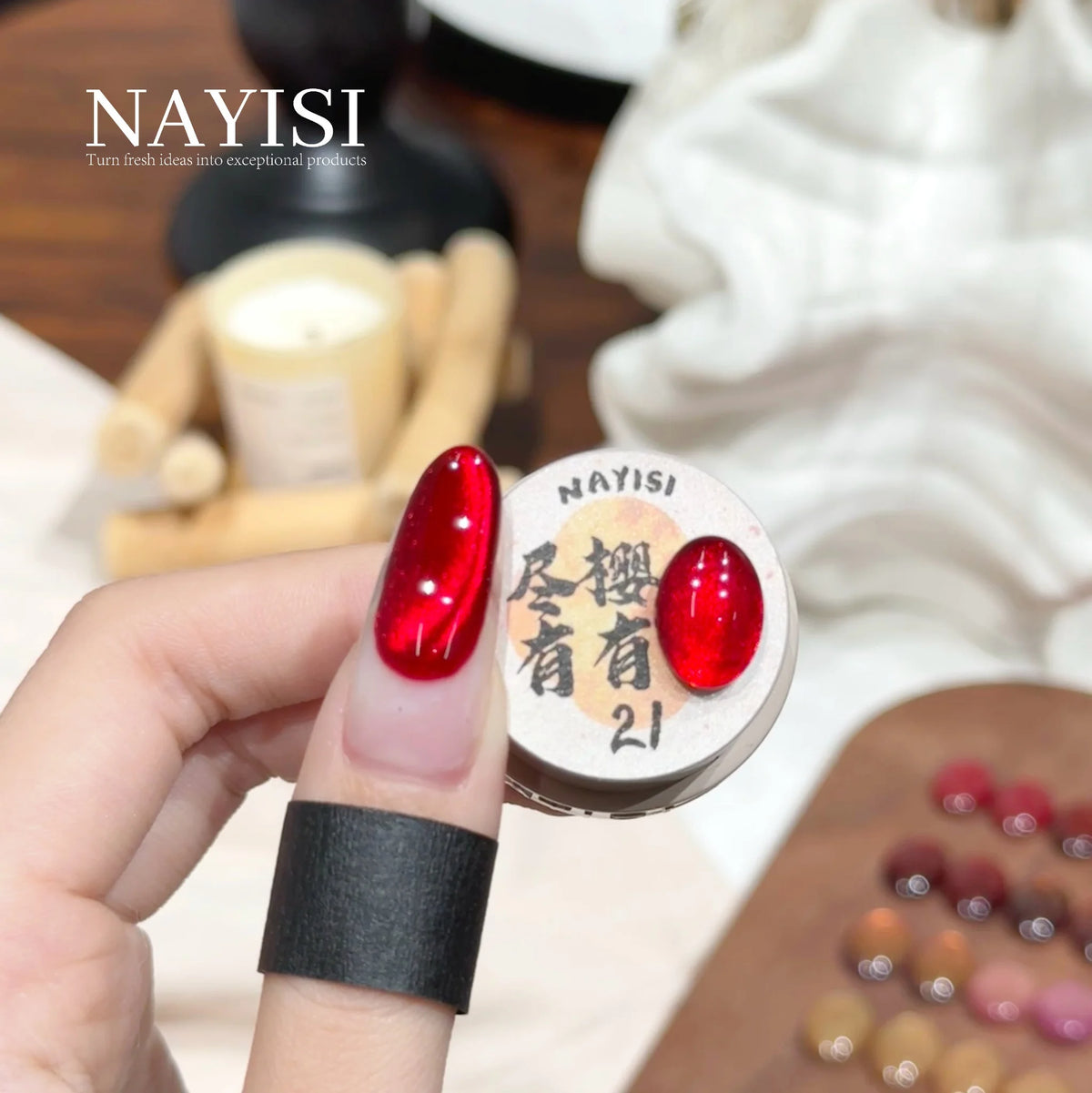 Riches and Treasures 3.0 21, cherry red cat eye, on a nail beside its jar