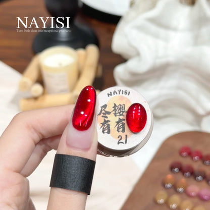 Riches and Treasures 3.0 21, cherry red cat eye, on a nail beside its jar