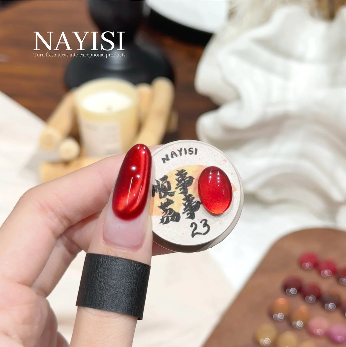 Riches and Treasures 3.0 23, deep crimson cat eye, on a nail beside its jar