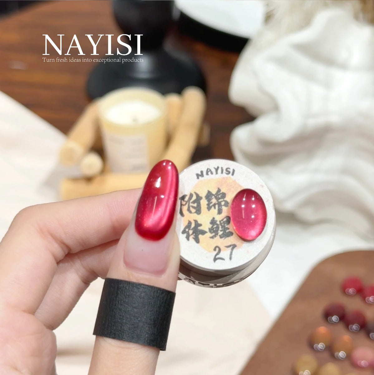 Riches and Treasures 3.0 27, raspberry red cat eye, on a nail beside its jar