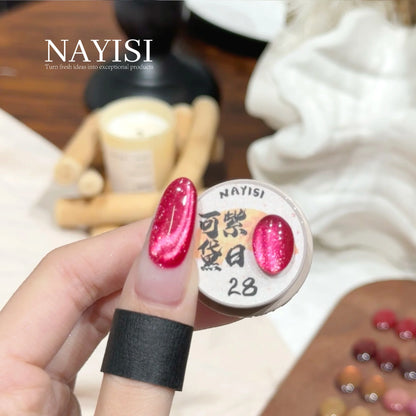 Riches and Treasures 3.0 28, rose red sparkle cat eye, on a nail beside its jar