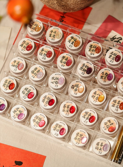 Close-up of the 30 jars with hand-lettered shade names on the lids