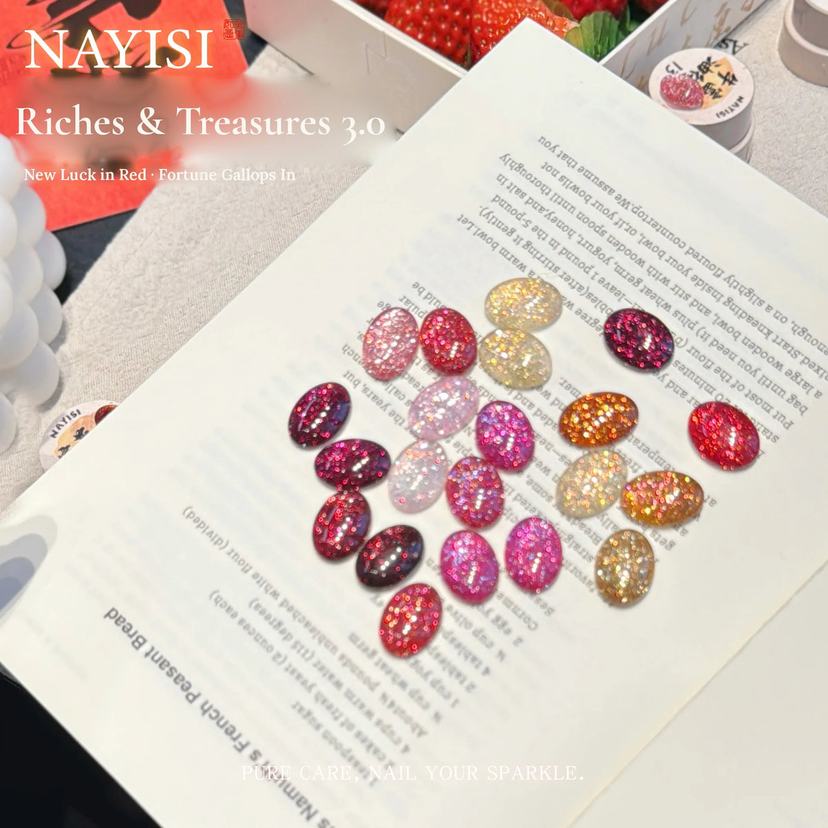 Riches and Treasures 3.0 sparkle tips in pink, red and gold on an open book