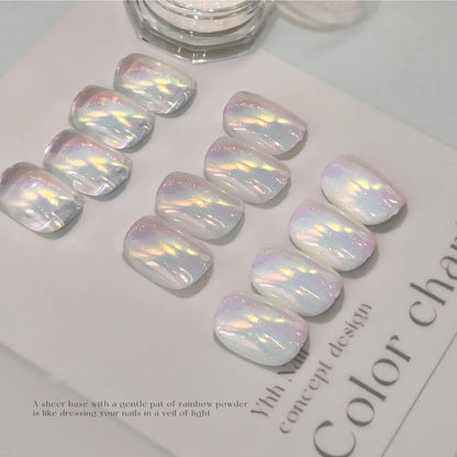 Rainbow powder over a sheer base, like a veil of light on the nails