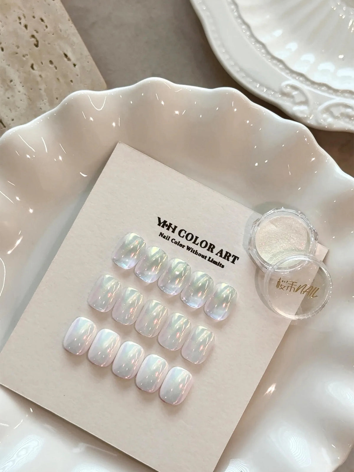 Rainbow powder swatch card and jar on a white plate