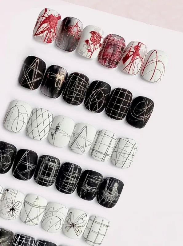 Spider gel line art on black and white nail tips: grids, webs, butterflies