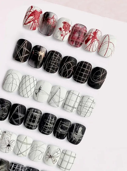 Spider gel line art on black and white nail tips: grids, webs, butterflies