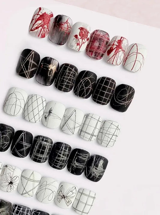 Spider gel line art on black and white nail tips: grids, webs, butterflies