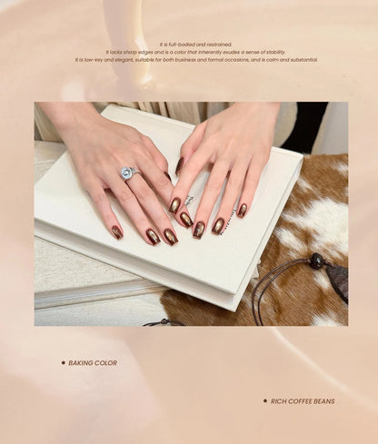 Rich coffee-brown cat eye manicure resting on a book