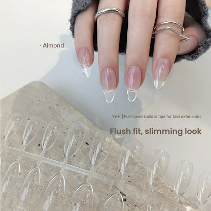 Hand wearing YHH clear almond full-cover tips over a pink base
