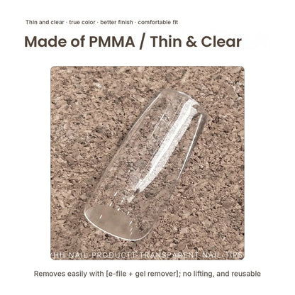 Single YHH clear PMMA full-cover tip on a cork background
