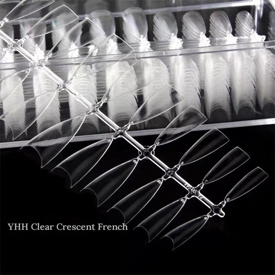 Close-up of YHH clear crescent French half-cover tips in their box