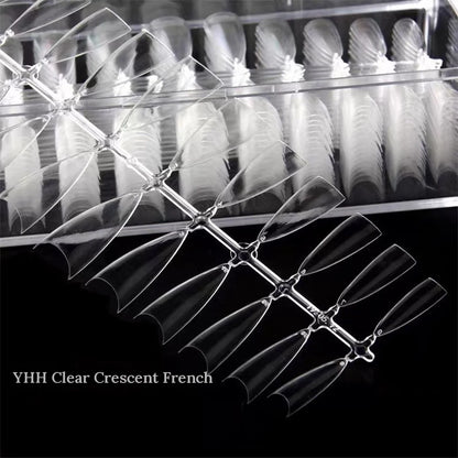 Close-up of YHH clear crescent French half-cover tips in their box