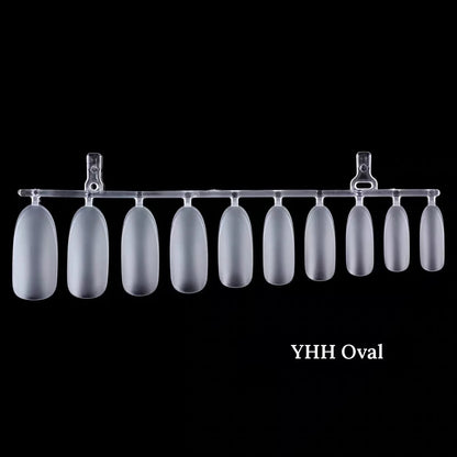 YHH frosted oval full-cover nail tips on a runner, black background