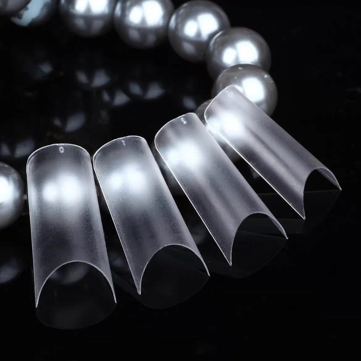 YHH frosted tube French tips fanned out beside pearls