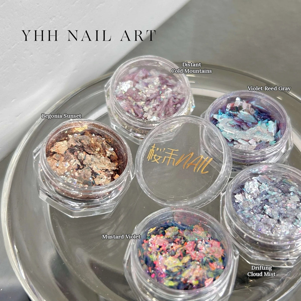 YHH Opal Powder jars arranged on a glass dish, shades labeled