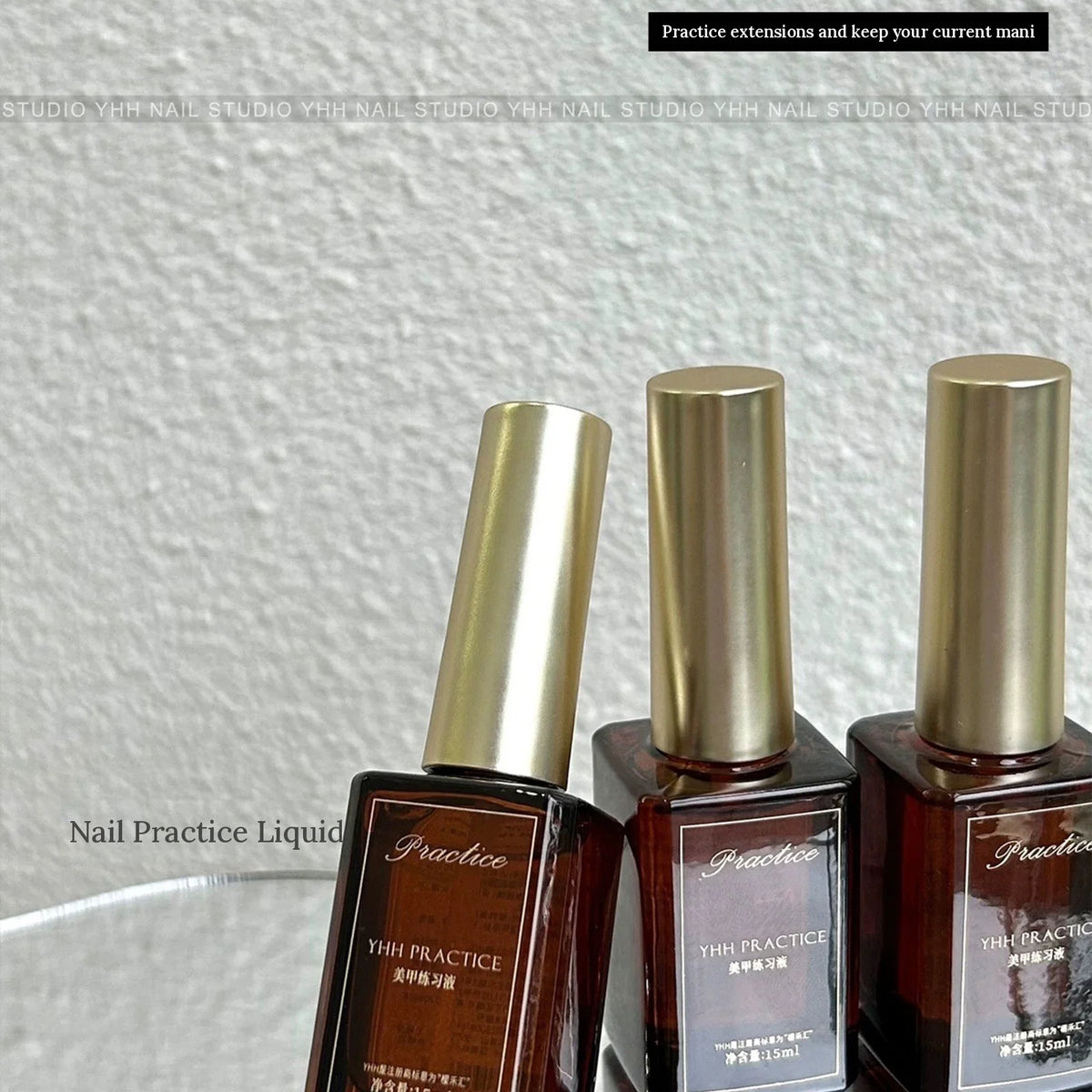 Three bottles of YHH nail practice liquid with gold caps