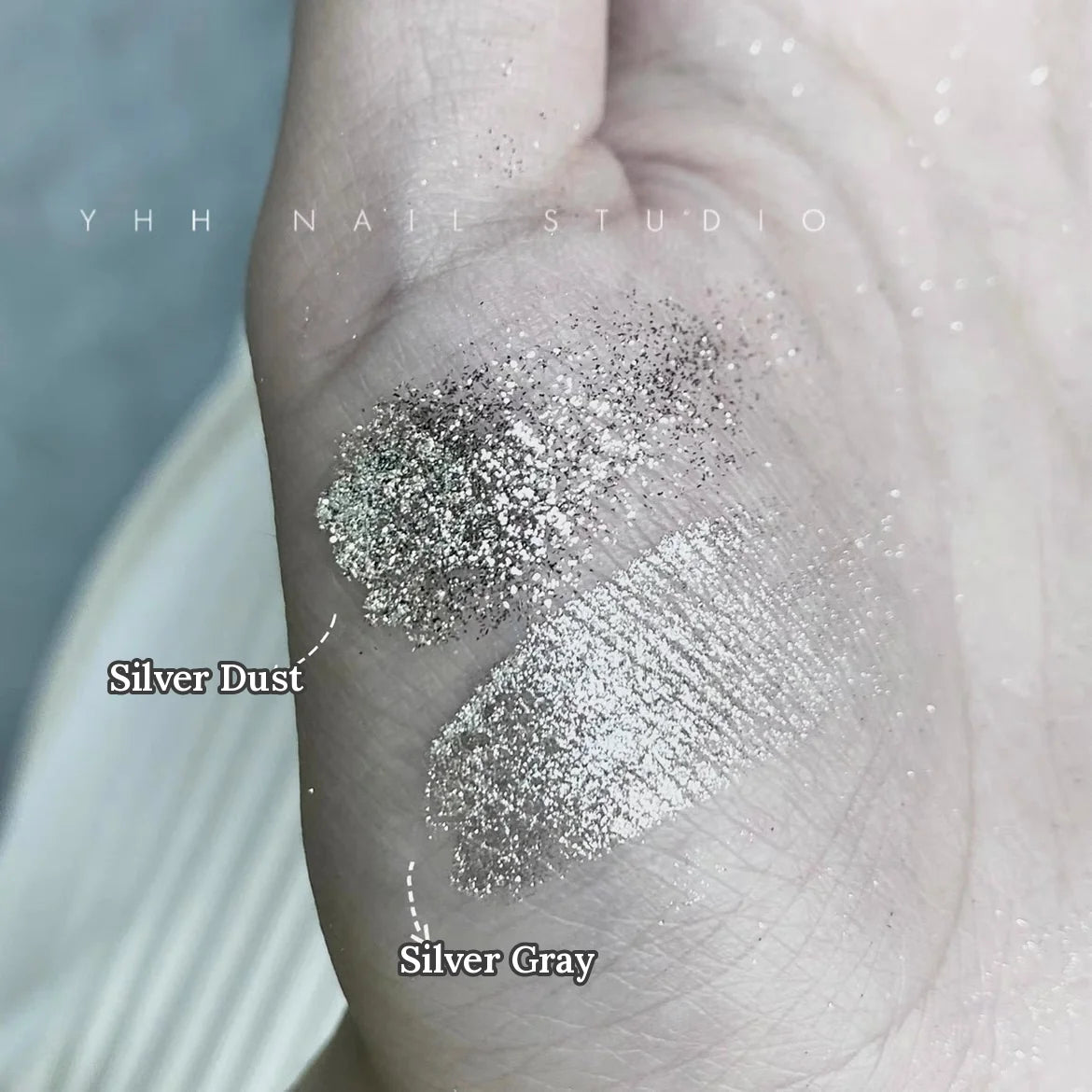 YHH Silver Dust and Silver Gray glitter swatched on the back of a hand