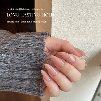 Long almond press-on nails in neutral pink applied with YHH Solid Gel